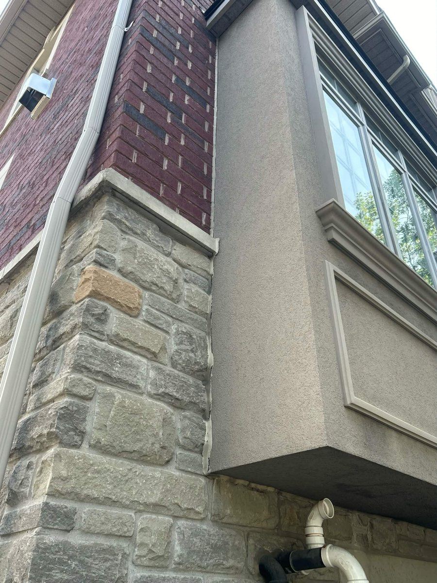 Before: Bay window corner — stone-to-frame transition